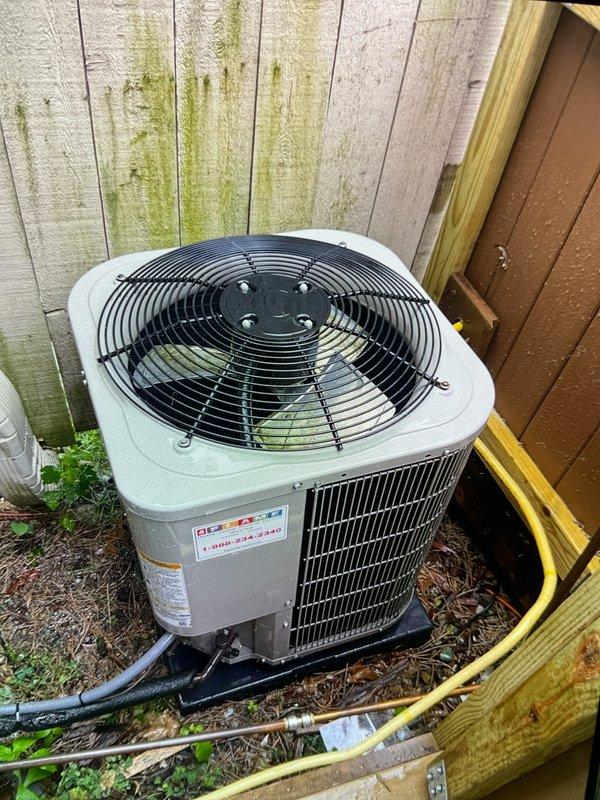 Completed comprehensive Gold AC inspection on 10+ year old single-zone system with air handler located in basement. Performed thorough examination of outdoor condenser unit, verified proper operation of compressor, fan motor, and capacitor. Inspected electrical connections, contactors, and refrigerant lines for wear and integrity. Checked condenser coil fins for debris accumulation and airflow obstruction. Documented equipment condition with photographs showing unit positioned on pad with refrigerant lines properly routed. All components found operating within normal parameters at time of inspection.