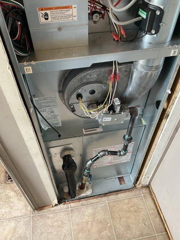 Completed full HVAC system installation including 70,000 BTU furnace and air conditioning unit at residential property. Installed new furnace with blower assembly, connected all electrical wiring per code requirements, and established proper ductwork connections. Reconnected AC condenser unit with refrigerant lines and brass valve fittings. Performed electrical service work including meter panel connections and circuit integration for new HVAC equipment. Verified all mechanical and electrical components are properly installed and operational. System tested successfully with AC cooling function confirmed working properly.
