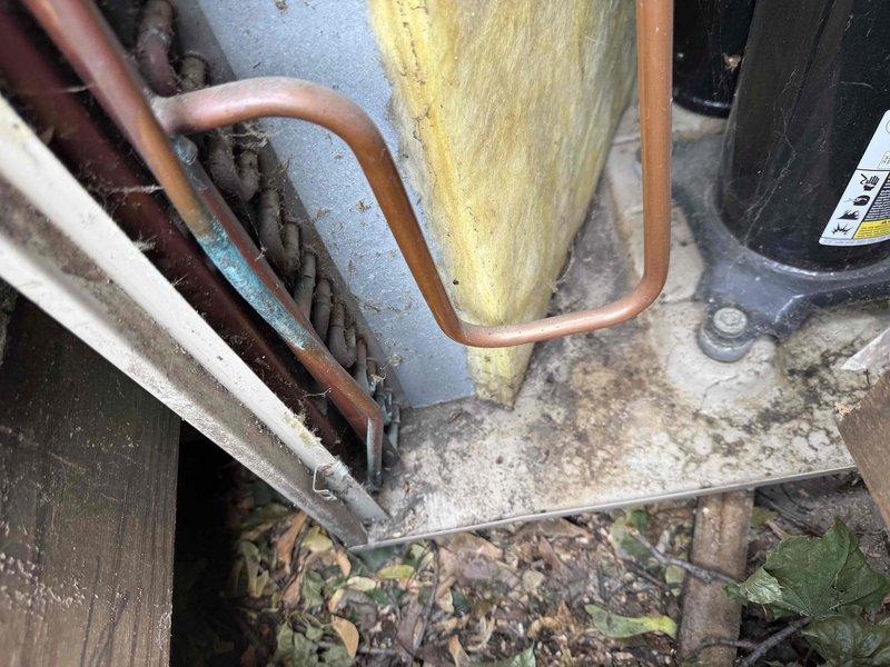 Completed comprehensive tune-up and inspection on Lennox outdoor condensing unit. Performed visual assessment of refrigerant lines, noting aged copper piping with surface discoloration and yellow fiberglass insulation on suction line. Inspected condenser cabinet, fan assembly, and electrical connections. Unit operational at time of service with no immediate repairs required.
