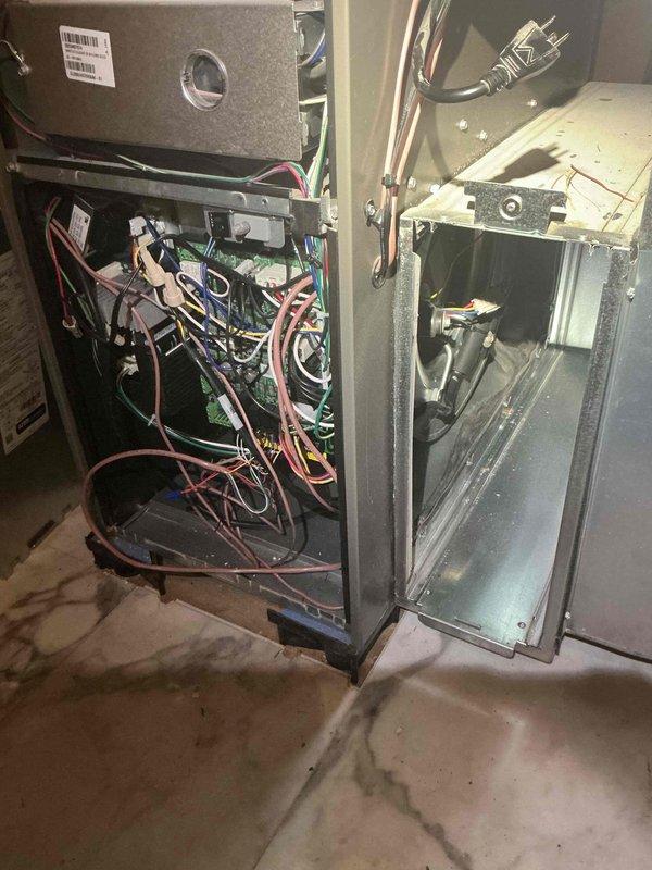 Responded to no-heat call on 2-month-old furnace displaying "waiting for equipment" message in basement location. Performed diagnostic inspection of unit with access panels removed, inspected control board wiring, electrical connections, and internal components. System restored to proper operation with heat confirmed at supply plenum and ductwork.