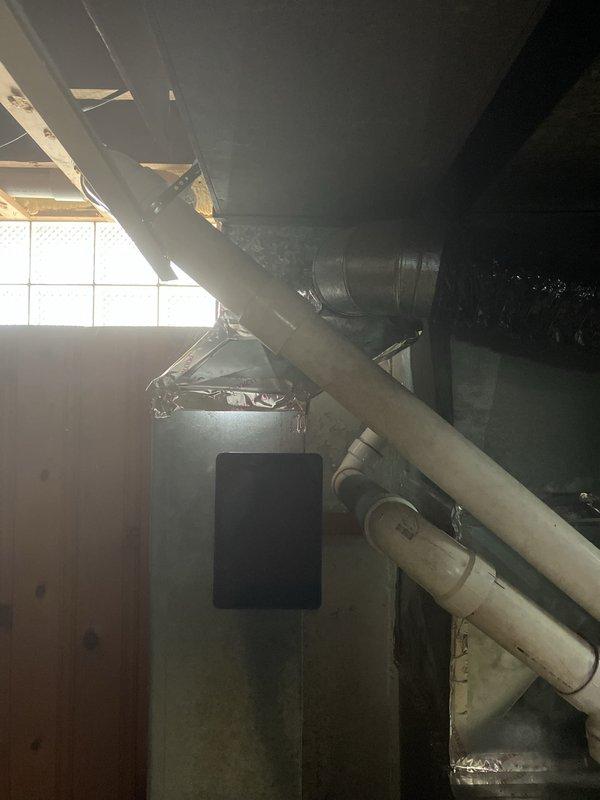 Responded to cooling complaint on 16+ year old air conditioning system not reaching desired temperature despite unit operation. Performed comprehensive assessment of existing HVAC equipment located in basement utility area, including inspection of air handler unit, ductwork configuration, and associated mechanical components. Documented current system condition through detailed photography showing aging equipment, flexible ductwork connections, PVC drainage lines, and overall installation layout to provide accurate replacement estimate for complete system upgrade.