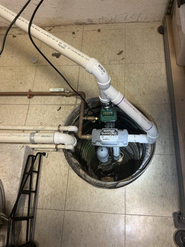 Responded to service call for non-operational sump pump with reported electrical issue. Upon inspection, diagnosed faulty control switch and compromised electrical connections in the pump assembly. Replaced defective gray control unit, secured all electrical wiring, and verified proper pump operation. Tested system through multiple cycles to ensure reliable activation and water discharge through existing PVC discharge piping. System restored to full operational status.