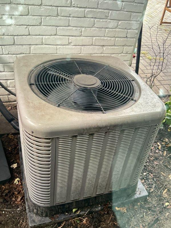 Completed comprehensive Gold AC inspection on 10-year-old residential air conditioning system with outdoor condenser unit located adjacent to home foundation and basement air handler. Performed full system evaluation including thermostat operation verification, visual inspection of outdoor unit casing and components, assessment of condenser coil condition, fan grille integrity check, and verification of proper unit leveling on concrete pad. All components found operating within normal parameters with unit showing typical age-related weathering but maintaining functional integrity.