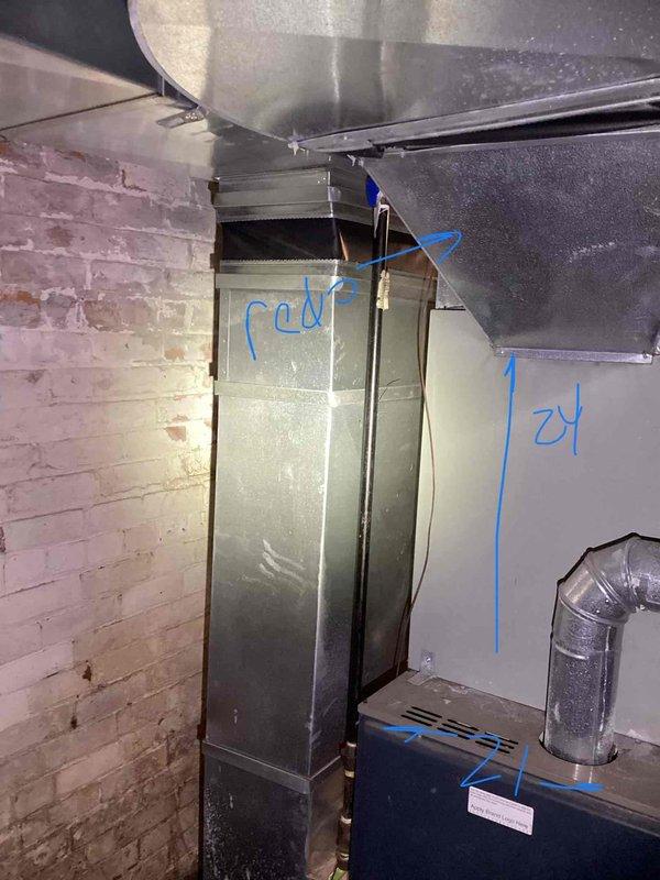 Conducted comprehensive site evaluation for complete HVAC system replacement at residential property. Assessed existing indoor air handler and ductwork configuration in basement mechanical room, documenting current plenum connections, galvanized ductwork condition, and furnace setup. Evaluated outdoor condensing unit positioned against building exterior behind chain-link fencing, noting equipment age, clearance requirements, and electrical service routing along brick wall. Photographed all existing equipment and installation conditions to provide accurate system sizing recommendations and replacement specifications for new central air conditioning system.