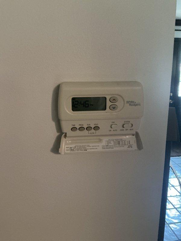 Responded to no cooling call on 20-year-old residential air conditioning system. Upon arrival, performed complete system evaluation including inspection of outdoor condensing unit located behind residence and indoor air handler unit in basement. Verified thermostat programming and settings on White-Rodgers programmable unit. Assessed refrigerant lines, condensate drain system with PVC piping, electrical connections, and ductwork configuration. System evaluation completed with diagnostic findings documented. Customer educated on system age and provided recommendations for aging equipment. Call completed with overview of system condition.
