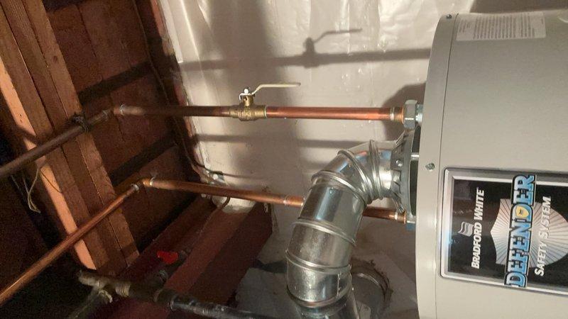 Completed Gold AC inspection on a 6-7 year old Bryant split system with air handler located in basement and condensing unit positioned on exterior concrete pad. Performed comprehensive evaluation of indoor and outdoor components, inspected refrigerant lines and electrical connections running between units, verified proper operation of condensing unit fan assembly and protective grilles, examined air handler cabinet and filtration system in basement utility area, and assessed overall system performance. All equipment found to be in working condition at time of inspection, with copper refrigerant lines, electrical conduit, and disconnect box properly secured and installed per manufacturer specifications.