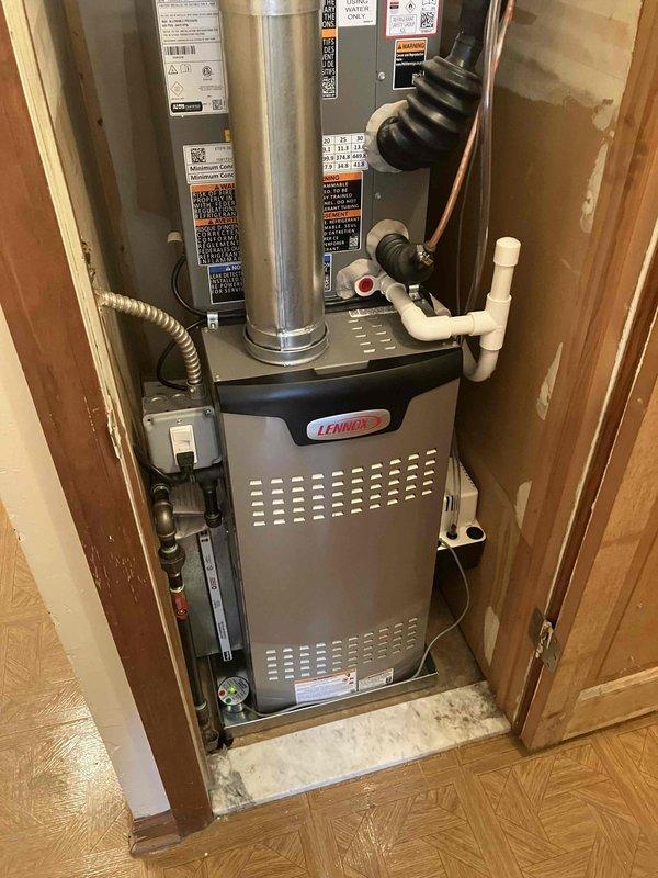 Completed full HVAC system installation including a 70,000 BTU Lennox furnace and 1.5-ton Lennox air conditioning unit with rear discharge configuration. Installed furnace in interior utility closet with proper venting, exhaust flue, condensate drainage system using PVC piping, and electrical connections including control wiring and disconnect. Mounted AC condensing unit on rubber isolation pad against exterior wall with appropriate clearances, installed electrical disconnect box, and completed refrigerant line connections. System installation included condensate pump, drain pan with wet switch safety device, and complete line set flush prior to charging. Requested and coordinated mechanical and electrical permits for the installation. Reconnected all electrical components to code specifications. Performed complete system startup, verified proper operation of both heating and cooling cycles, and confirmed all safety devices functioning correctly.