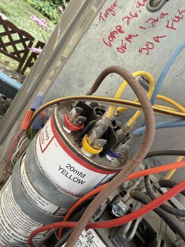 Responded to no-cooling call on 20-year-old residential air conditioning system. Upon inspection, found outdoor condensing unit completely depleted of refrigerant, indicating significant leak in aged system. Evaluated dual capacitor and electrical connections, which showed considerable weathering and dust accumulation consistent with unit age. Inspected indoor blower motor assembly, confirming operational status. Given the system's age at two decades—well beyond typical 15-year lifespan—and complete refrigerant loss, advised customer that locating and repairing leak followed by recharge would not be cost-effective compared to full system replacement. Documented equipment condition with photos showing capacitor, wiring connections, and blower assembly. Recommended replacement with modern high-efficiency unit to restore cooling and improve energy performance.