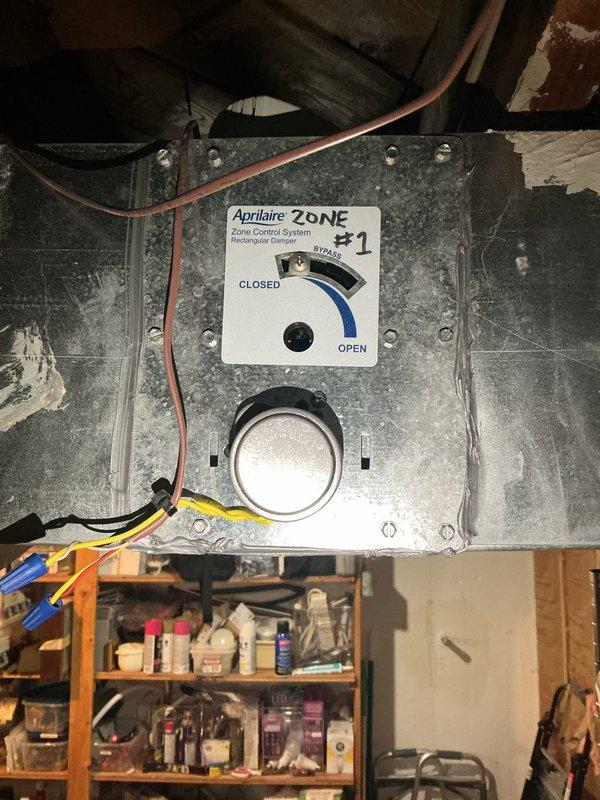 Responded to callback for loud ringing sound from newly installed AC system located in basement. Upon inspection, identified noise originating from Aprilaire zone control damper actuator. Found Honeywell damper motor experiencing mechanical binding during operation, causing audible ringing during zone cycling. Adjusted damper position and verified proper operation of zone control system. Cycled system through multiple zone calls to confirm noise elimination and proper damper movement between open, closed, and bypass positions.