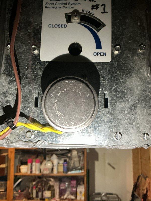 Responded to callback for loud ringing sound from newly installed AC system located in basement. Upon inspection, identified noise originating from Aprilaire zone control damper actuator. Found Honeywell damper motor experiencing mechanical binding during operation, causing audible ringing during zone cycling. Adjusted damper position and verified proper operation of zone control system. Cycled system through multiple zone calls to confirm noise elimination and proper damper movement between open, closed, and bypass positions.