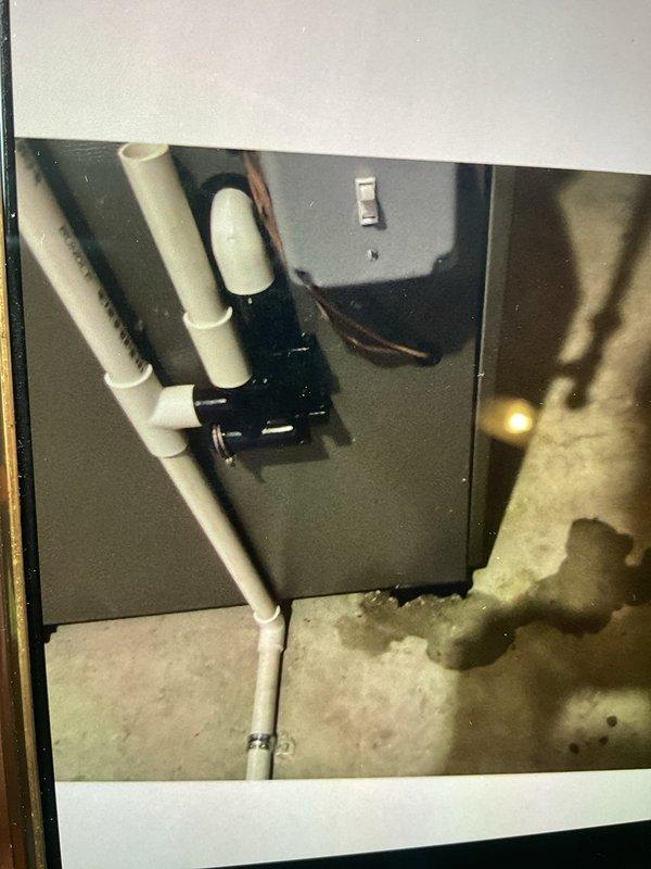 Responded to report of water leak near HVAC system in basement. Upon arrival, inspected 6-month-old forced air heating and cooling unit and surrounding area. Examined air handler cabinet, refrigerant lines, and PVC condensate drain piping for signs of moisture or active leaking. Checked condensate drain system for proper flow and verified trap functionality. Inspected AprilAire humidifier control settings and measured temperature readings at ductwork, which indicated 156°F at supply plenum. Assessed concrete floor for water damage and traced potential leak sources. Verified all connections at air handler were secure and properly sealed. System operational at time of inspection with no active leak observed.