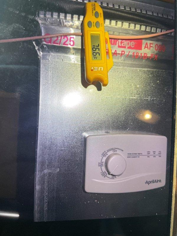 Responded to report of water leak near HVAC system in basement. Upon arrival, inspected 6-month-old forced air heating and cooling unit and surrounding area. Examined air handler cabinet, refrigerant lines, and PVC condensate drain piping for signs of moisture or active leaking. Checked condensate drain system for proper flow and verified trap functionality. Inspected AprilAire humidifier control settings and measured temperature readings at ductwork, which indicated 156°F at supply plenum. Assessed concrete floor for water damage and traced potential leak sources. Verified all connections at air handler were secure and properly sealed. System operational at time of inspection with no active leak observed.