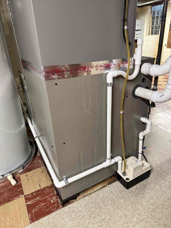 Successfully completed installation of 3-ton air conditioning system with matching evaporator coil in rear yard location. Installed new outdoor condensing unit and indoor coil, connecting to existing Luxaire furnace system in basement mechanical room. Established proper refrigerant lines, electrical connections, and condensate drainage system with pump. Configured white PVC condensate piping with appropriate fittings and routing to ensure proper drainage. Installed Sensi thermostat for system control. Reconnected all necessary components and verified proper system operation. Mechanical permit obtained prior to installation. System qualifies for utility rebate program.