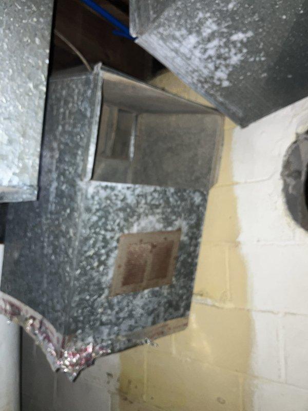 Conducted furnace replacement estimate at residential property. Inspected existing HVAC system including main supply ductwork and air distribution components in basement utility area. Documented current equipment configuration with detailed measurements of galvanized metal ductwork showing signs of age and dust accumulation. Evaluated structural conditions of installation area including concrete block walls and foundation space. Assessed duct connections, junction points, and access panels to determine compatibility requirements for new furnace installation. Provided comprehensive replacement quote based on observed system conditions and customer requirements.