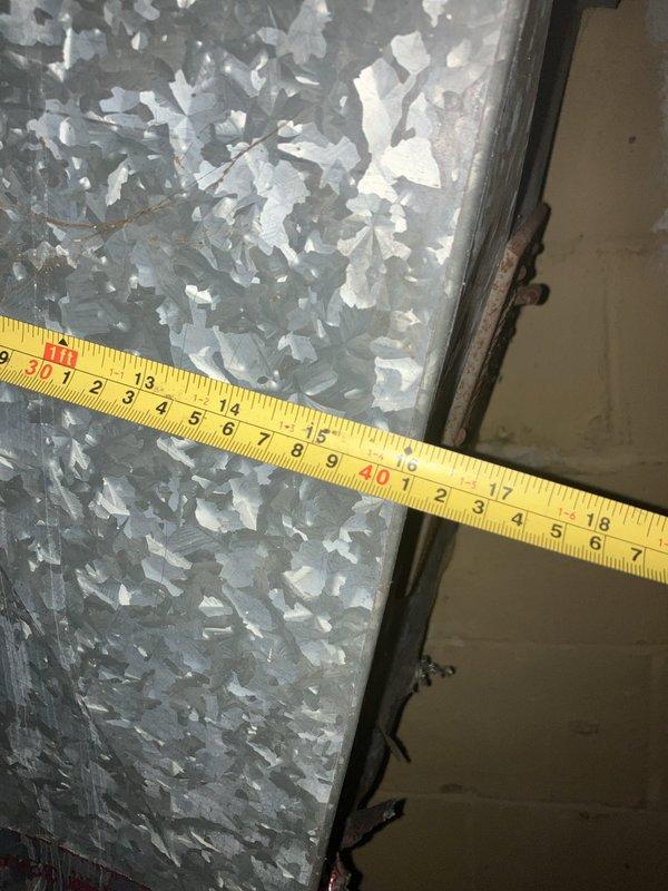 Conducted furnace replacement estimate at residential property. Inspected existing HVAC system including main supply ductwork and air distribution components in basement utility area. Documented current equipment configuration with detailed measurements of galvanized metal ductwork showing signs of age and dust accumulation. Evaluated structural conditions of installation area including concrete block walls and foundation space. Assessed duct connections, junction points, and access panels to determine compatibility requirements for new furnace installation. Provided comprehensive replacement quote based on observed system conditions and customer requirements.