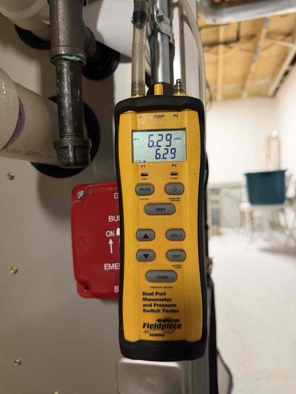 Responded to service call to perform gas pressure testing on Bradford White water heater experiencing ongoing operational issues. Utilized Fieldpiece dual port manometer to measure and verify gas supply pressure at the unit, obtaining readings of 6.29 and 6.23 inches water column. Documented Jcon System control unit settings and current configuration, photographed test results and equipment for manufacturer warranty claim submission.