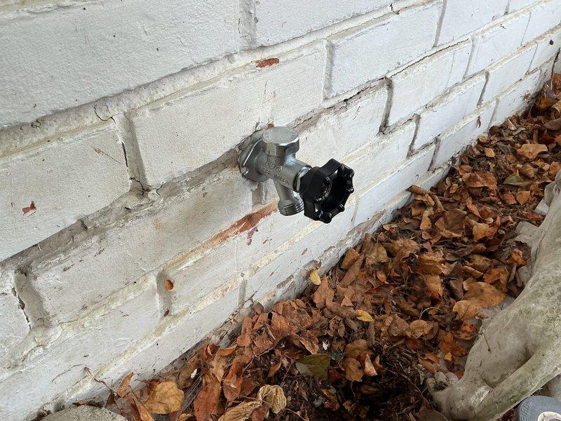 Replaced main water meter valve assembly located in basement crawl space between floor joists. Removed existing weathered galvanized valve and installed new brass ball valve with yellow handle for improved shutoff control and accessibility. Connected valve to existing copper supply lines serving the water distribution system. Additionally, replaced two frost-free exterior wall spigots on building perimeter. All new fixtures tested for proper operation and verified leak-free connections. Picked up replacement parts from Madison Plumbing supply house prior to installation.