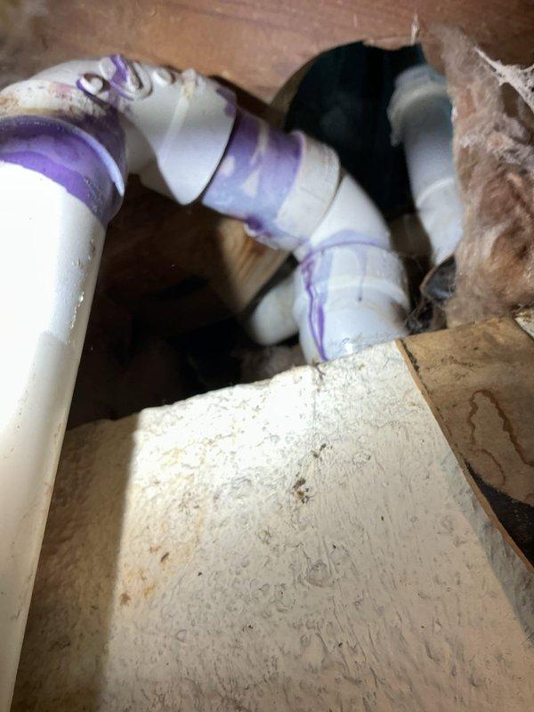 Responded to active leak in shower drain line between first floor bathroom and basement. Located failed PVC pipe section visible from basement ceiling. Removed damaged piping, applied PVC primer and solvent cement, and installed new section with proper fittings and elbow joints. Tested system under full water flow to verify repair integrity and confirmed no further leakage.