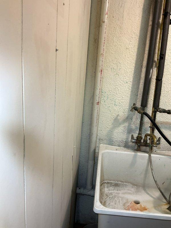 Responded to active leak in shower drain line between first floor bathroom and basement. Located failed PVC pipe section visible from basement ceiling. Removed damaged piping, applied PVC primer and solvent cement, and installed new section with proper fittings and elbow joints. Tested system under full water flow to verify repair integrity and confirmed no further leakage.
