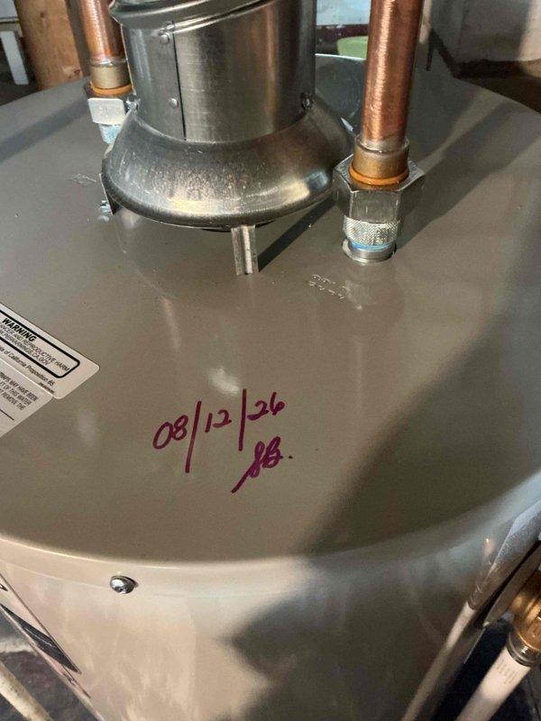 Replaced 40-gallon Bradford White gas water heater in basement due to tank leaking from the bottom. The 8-year-old unit was replaced under warranty with gas connection kit and copper piping kit installed with the new tank. All connections, venting, and system operations were verified upon completion.