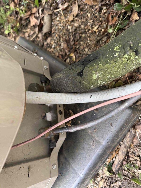 Returned to property to address ongoing cooling issue with outdoor condensing unit. Replaced defective plug switch combo that was preventing proper unit operation. Upon inspection, noted significant moss and algae accumulation on refrigerant lines indicating prolonged moisture exposure and need for routine maintenance. Verified electrical connections secure and tested unit operation after component replacement. System now cycling properly and cooling effectively. Recommended regular maintenance to prevent future biological growth on exterior components and ensure optimal performance.