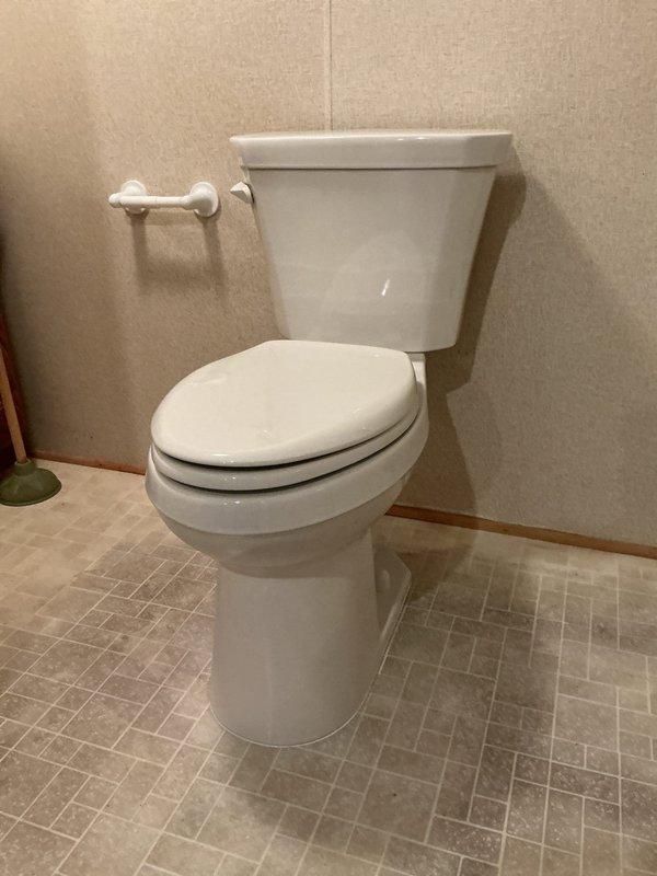 Completed toilet installation per approved estimate. Removed existing unit and installed new standard two-piece white porcelain toilet with tank and bowl assembly. Verified proper mounting, secure water supply connection, and leak-free operation upon completion.