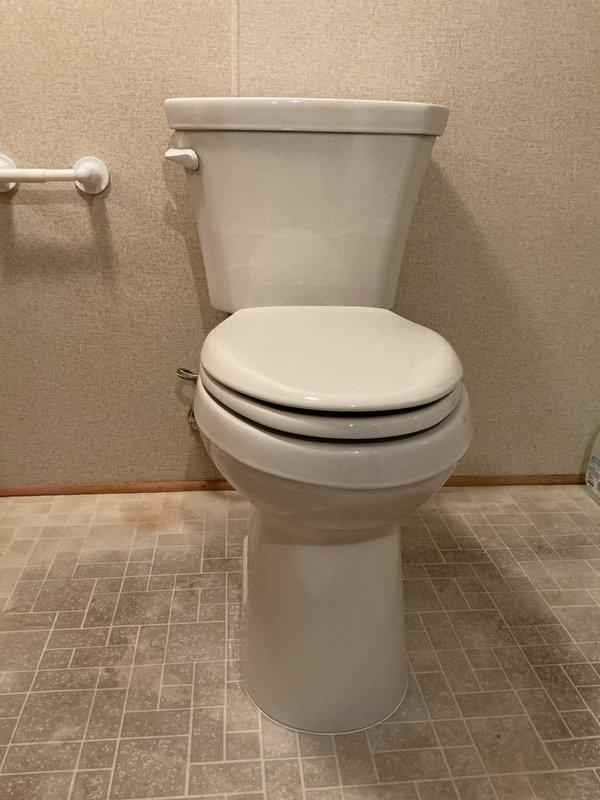 Completed toilet installation per approved estimate. Removed existing unit and installed new standard two-piece white porcelain toilet with tank and bowl assembly. Verified proper mounting, secure water supply connection, and leak-free operation upon completion.