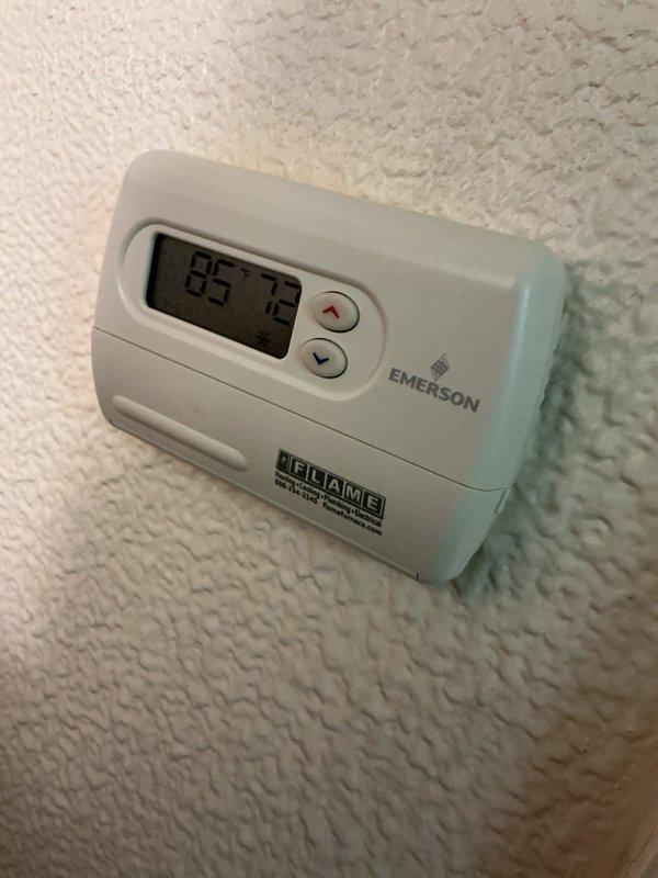 Responded to service call for thermostat malfunction where air conditioning system was continuously running and could not be shut off. Upon arrival, inspected Emerson digital thermostat displaying current temperature of 85°F with setpoint at 72°F. Evaluated thermostat wiring connections and tested control functionality of temperature adjustment buttons. Examined cooling system equipment located in basement area, including ductwork, air handler components, and condensate pump assembly with drip pan. Diagnosed issue with thermostat communication to cooling system, preventing proper cycle termination. Corrected thermostat settings and verified proper system response to temperature calls. Tested system through complete cooling cycle to confirm air conditioning unit now properly shuts off when reaching setpoint temperature. System operating correctly with thermostat maintaining accurate temperature control and allowing manual override functions.