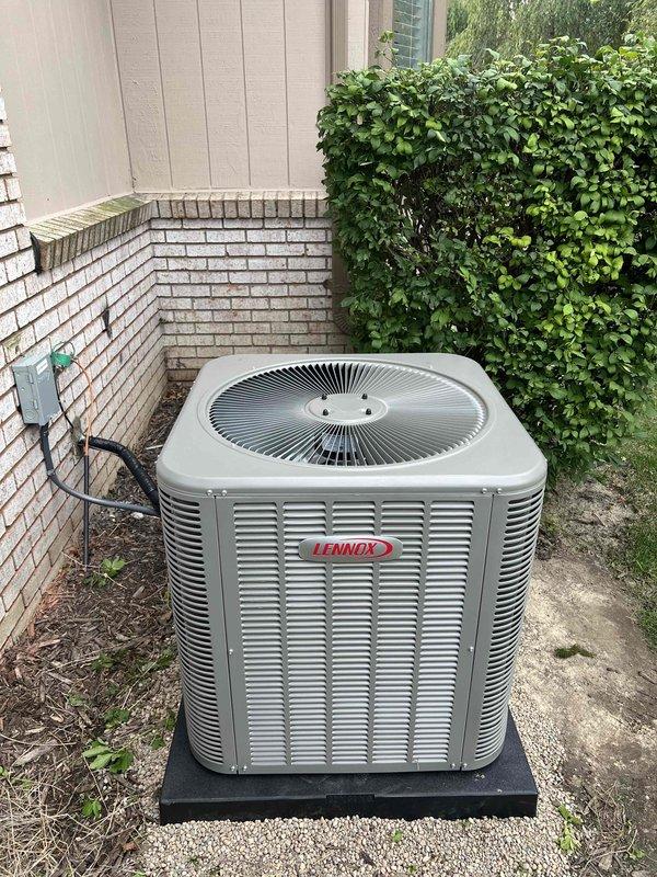 Completed installation of 2.5-ton Lennox air conditioning system with matching evaporator coil at residential property. Unit was positioned in rear yard location on composite mounting pad, with electrical disconnect installed on adjacent brick wall and proper conduit routing. System was reconnected to existing mechanical infrastructure per permit specifications, tested for proper operation, and left in full working condition.