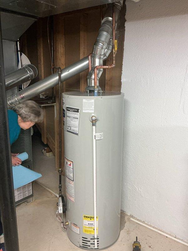 Successfully removed and replaced an existing 75-gallon residential water heater with a new 50-gallon unit in the basement utility area. The installation included disconnecting and capping the existing copper supply lines, removing the old unit, and installing the new water heater with proper venting connections to the existing ductwork system. All plumbing connections were secured with appropriate fittings and the unit was tested for proper operation. Additionally, repaired a loose sink stopper assembly on the basement bathroom sink, restoring full functionality to the drain mechanism.