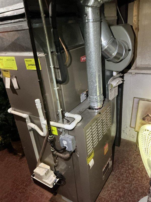 Completed comprehensive Gold AC Inspection on 8-year-old residential air conditioning system. Performed seasonal tune-up on outdoor condenser unit located at rear of property, which included moving obstructions from around compressor for proper access, cleaning condenser coils, inspecting electrical connections, checking refrigerant levels, testing capacitor and contactor operation, verifying proper airflow through louvers, and confirming system operational parameters. Indoor air handler and furnace components inspected for proper integration with cooling system. All components found operating within normal specifications with no deficiencies noted. System tested under load and confirmed to be cooling effectively with no symptoms or concerns reported by customer prior to service.