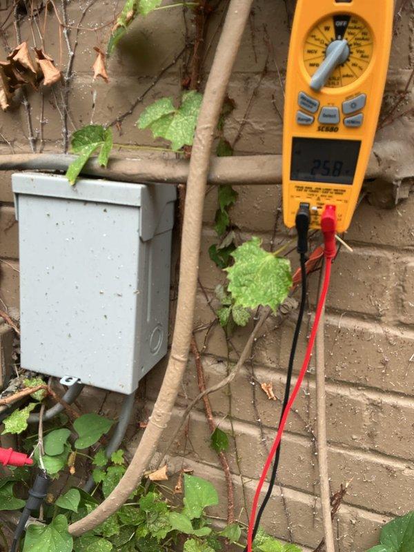 Responded to no cooling call following yard work near outdoor condenser unit. Upon arrival, found 3-year-old cooling system non-operational. Performed diagnostic testing with multimeter at outdoor unit, measuring 25.0 volts at disconnect, indicating power supply issue. Traced electrical circuit from condenser through external disconnect box mounted on exterior wall. Discovered damaged low-voltage wiring that had been severed during recent landscaping activities near unit. Repaired damaged control wiring, restored proper electrical connections, and verified proper voltage at all connection points. Tested system operation through complete cooling cycle. Unit now operating within normal parameters with proper compressor and fan motor function. Recommended keeping vegetation and future yard work clear of condenser unit and associated wiring to prevent similar issues.