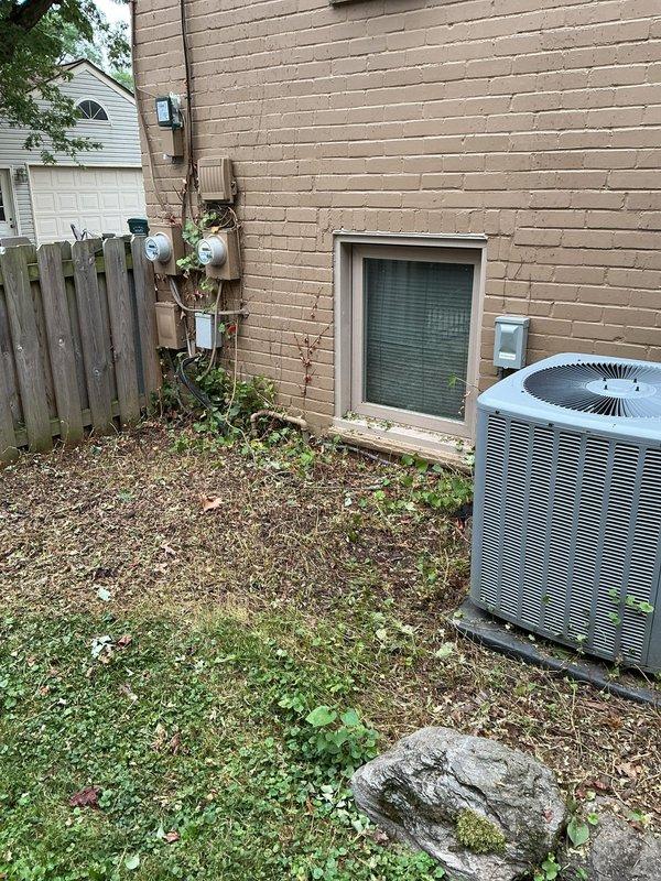 Responded to no cooling call following yard work near outdoor condenser unit. Upon arrival, found 3-year-old cooling system non-operational. Performed diagnostic testing with multimeter at outdoor unit, measuring 25.0 volts at disconnect, indicating power supply issue. Traced electrical circuit from condenser through external disconnect box mounted on exterior wall. Discovered damaged low-voltage wiring that had been severed during recent landscaping activities near unit. Repaired damaged control wiring, restored proper electrical connections, and verified proper voltage at all connection points. Tested system operation through complete cooling cycle. Unit now operating within normal parameters with proper compressor and fan motor function. Recommended keeping vegetation and future yard work clear of condenser unit and associated wiring to prevent similar issues.