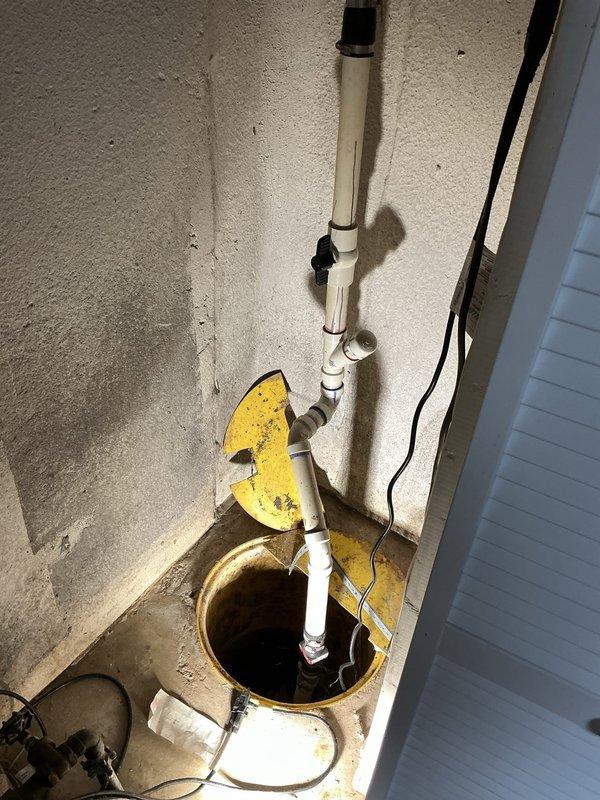 Completed comprehensive whole home plumbing inspection with emphasis on kitchen area in preparation for upcoming remodeling project. Inspected and documented sump pump system in basement, including PVC discharge piping, check valve configuration, and pump pit condition; noted operational status and water accumulation levels. Thoroughly examined under-sink plumbing infrastructure in kitchen area, evaluating PVC drainage system, supply line connections, and pipe joint integrity. Identified deteriorated wall conditions behind cabinetry with significant paint and plaster damage requiring attention during remodel. Documented all findings with photographic evidence for customer reference and contractor coordination.