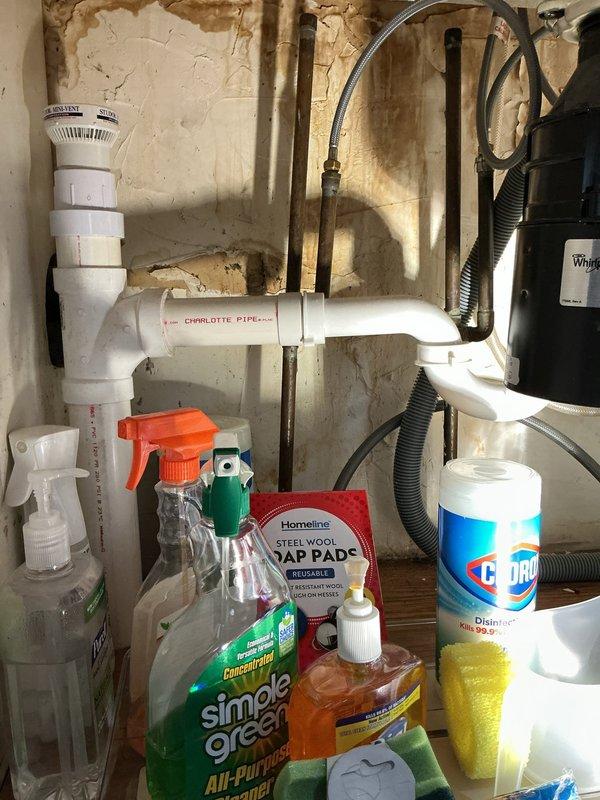 Completed comprehensive whole home plumbing inspection with emphasis on kitchen area in preparation for upcoming remodeling project. Inspected and documented sump pump system in basement, including PVC discharge piping, check valve configuration, and pump pit condition; noted operational status and water accumulation levels. Thoroughly examined under-sink plumbing infrastructure in kitchen area, evaluating PVC drainage system, supply line connections, and pipe joint integrity. Identified deteriorated wall conditions behind cabinetry with significant paint and plaster damage requiring attention during remodel. Documented all findings with photographic evidence for customer reference and contractor coordination.