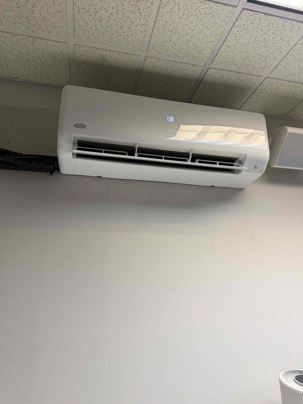 Completed scheduled AC tune-up maintenance on a 14-year-old Carrier 38MARBQ18AA3 split system air conditioner serving the IT room. Performed comprehensive inspection of wall-mounted indoor unit and outdoor condensing unit, verified refrigerant charge of R-410A system, checked electrical connections and confirmed operating amperage within specifications, cleaned evaporator coil and verified proper airflow through discharge vents, and tested thermostat operation with unit responding correctly at 68°F setpoint. System operating normally with no deficiencies noted.