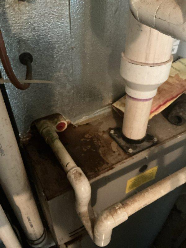 Responded to service call for water leaking from PVC pipe on residential furnace system. Upon inspection, identified condensate drain line issue with visible water staining in drain pan beneath air handler unit. Cleared condensate drain obstruction, verified proper drainage flow through PVC piping system, and confirmed trap functionality. Inspected all condensate pump connections and drain line routing. System tested and confirmed operational with proper heating capability maintained throughout service. No further leakage observed upon completion.