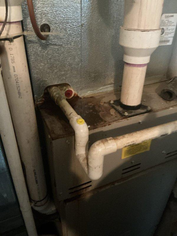 Responded to service call for water leaking from PVC pipe on residential furnace system. Upon inspection, identified condensate drain line issue with visible water staining in drain pan beneath air handler unit. Cleared condensate drain obstruction, verified proper drainage flow through PVC piping system, and confirmed trap functionality. Inspected all condensate pump connections and drain line routing. System tested and confirmed operational with proper heating capability maintained throughout service. No further leakage observed upon completion.