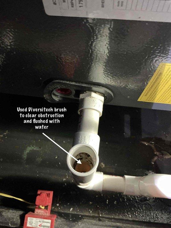 Responded to service call for 6-year-old AC unit in attic with water leakage issue. Upon inspection, identified obstruction in condensate drain line causing water backup. Used Diversitech brush to clear blockage from PVC drainage pipe assembly and flushed system with water to ensure proper flow. Verified condensate drain line was operating correctly with no further leakage detected. Unit tested and returned to normal operation.