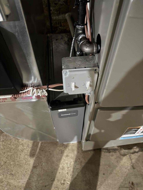 Returned to site to diagnose commercial air conditioning unit that had frozen over during previous visit. Upon inspection, system had thawed sufficiently to allow for proper evaluation. Accessed indoor unit and inspected contactor assembly, examining electrical connections and contact points for signs of failure or deterioration. Removed and inspected contactor to verify proper operation and assess condition of terminals and contact surfaces. Checked all electrical connections at terminal points for tightness and proper voltage supply. Evaluated airflow components and ductwork connections to rule out restricted airflow as contributing factor to freeze-up condition. Documented equipment condition with photos showing furnace installation, control panel, copper refrigerant lines, and contactor assembly for service records.