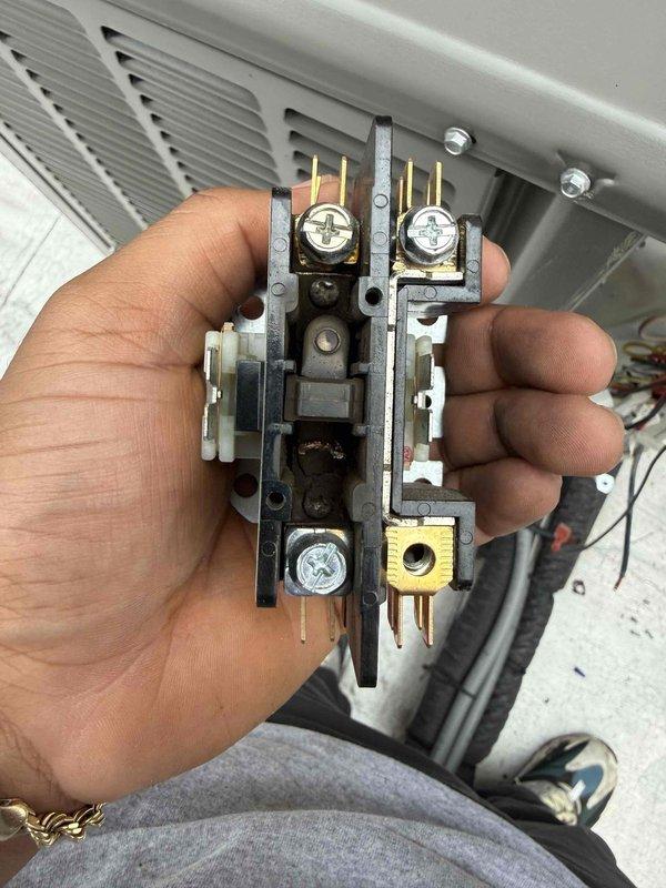 Returned to site to diagnose commercial air conditioning unit that had frozen over during previous visit. Upon inspection, system had thawed sufficiently to allow for proper evaluation. Accessed indoor unit and inspected contactor assembly, examining electrical connections and contact points for signs of failure or deterioration. Removed and inspected contactor to verify proper operation and assess condition of terminals and contact surfaces. Checked all electrical connections at terminal points for tightness and proper voltage supply. Evaluated airflow components and ductwork connections to rule out restricted airflow as contributing factor to freeze-up condition. Documented equipment condition with photos showing furnace installation, control panel, copper refrigerant lines, and contactor assembly for service records.