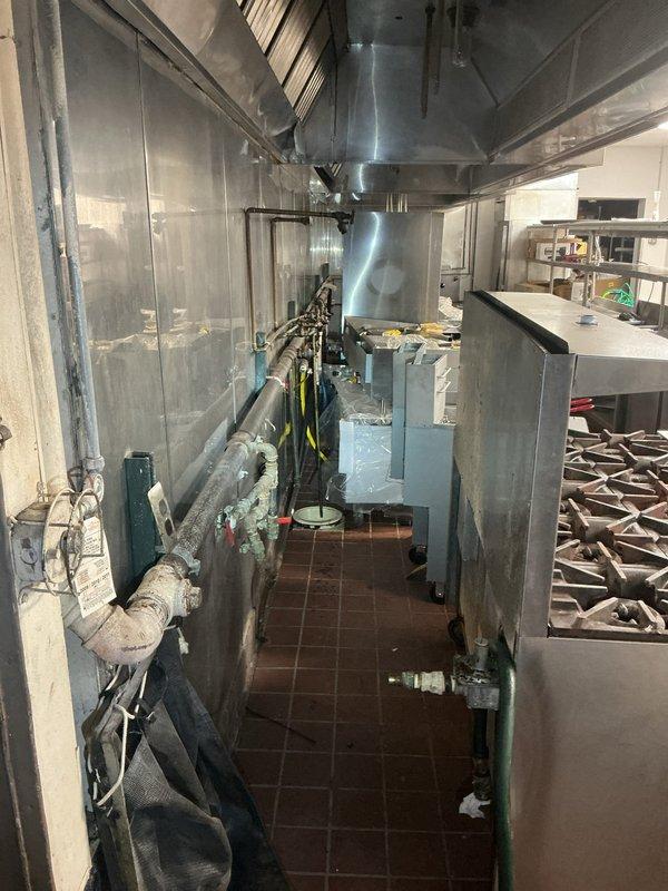 Conducted on-site assessment of commercial kitchen to provide estimate for gas line connection to multiple cooking appliances. Evaluated existing gas infrastructure, including routing requirements for professional-grade range, deep fryer, and additional kitchen equipment positioned under exhaust hood system. Inspected current gas line configuration, pipe sizing requirements, and connection points needed to safely supply gas to all equipment per commercial code specifications.