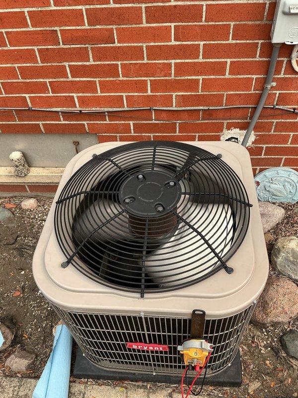 Responded to no cooling complaint on 5-year-old residential air conditioning system. Performed diagnostic evaluation of outdoor condenser unit located at basement level. Utilized digital manifold gauges to measure system pressures and assess refrigerant charge levels. System inspection revealed operational deficiencies requiring technical assessment of compressor function, refrigerant flow, and electrical components to determine root cause of warm air discharge from indoor unit.