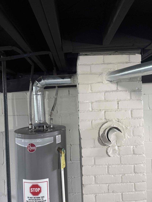 Completed system inspection on 2005 forced air furnace located in basement at homeowner's request following recent move-in. Evaluated vertical furnace unit and associated ductwork for operational status and necessary repairs. Confirmed exhaust pipe requires replacement due to age and condition concerns. Documented equipment configuration including air handler, ductwork connections, and venting system with photographic evidence for repair recommendations.