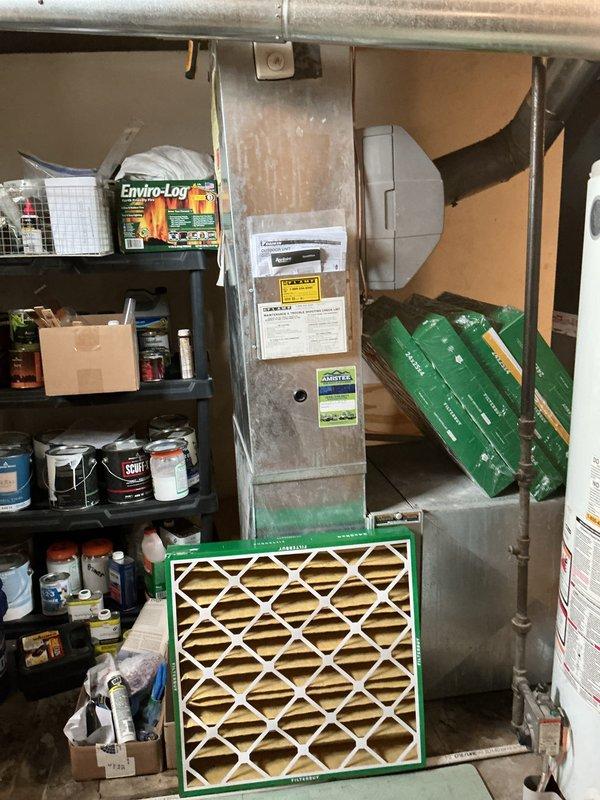 # Summary

Completed comprehensive Gold AC Inspection on 2-year-old residential air conditioning system with no reported issues, performing preventive maintenance on basement fan coil unit and outdoor condensing unit to ensure optimal summer performance.

# Work Performed

Performed complete Gold AC maintenance inspection on residential split system. Inspected and verified proper operation of digital thermostat displaying 70°F with circulating air mode engaged. Conducted thorough examination of indoor fan coil unit located in basement mechanical room.

Evaluated air filtration system, noting pleated filter with green cardboard frame positioned at furnace base with additional replacement filters stored on-site. Verified proper filter sizing and condition for optimal airflow and system efficiency.

Inspected outdoor condensing unit for proper operation, checking refrigerant pressures, electrical connections, and mechanical components. Verified compressor startup and run characteristics w