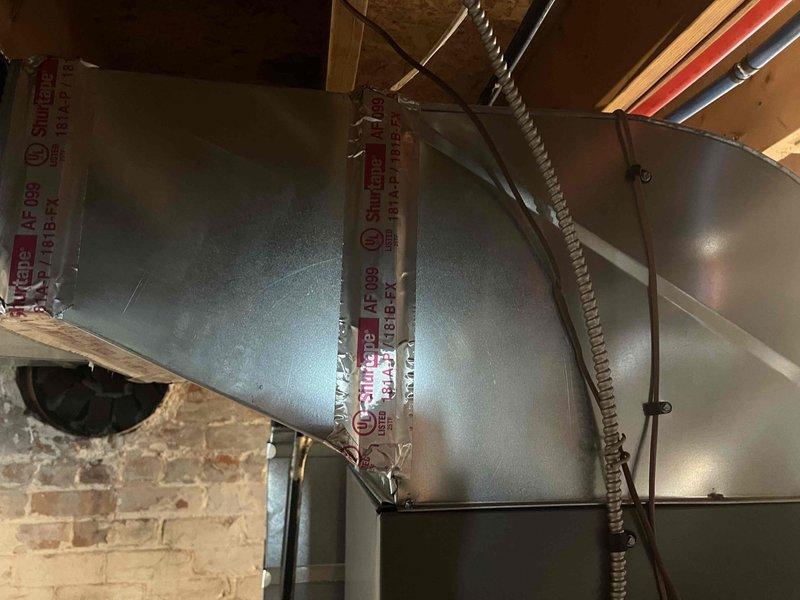 Completed installation of new air conditioning system and evaporator coil in basement mechanical room. Installed new air handler unit with proper condensate drainage using white PVC piping, connected black flexible conduit for electrical service, and integrated metal ductwork with existing HVAC infrastructure. System was properly mounted, all connections secured, and unit positioned for optimal airflow and serviceability in accordance with manufacturer specifications and local building codes.