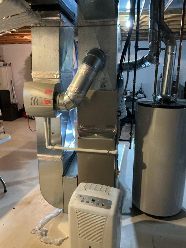 Responded to condensation leak from PVC drain line on 10-year-old AC system located in basement. Inspected condensate drainage system and cleared blockage in primary drain line. Verified proper drainage flow and confirmed dehumidifier unit was operating correctly to manage basement humidity levels at 33%.