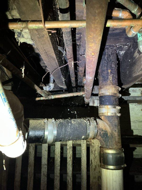Responded to service call for gas pressure test and multiple reported gas leaks in residential property. Upon inspection of basement gas piping system, identified 10-12 leak points throughout aging gas distribution lines, including corroded pipe connections, deteriorated threaded joints, and compromised fittings on horizontal and vertical runs. Conducted comprehensive pressure test to verify system integrity and locate all leak sources. Documented existing conditions of gas piping infrastructure, noting extensive corrosion on metal pipes, aged hose clamps at connection points, and overall deterioration of mechanical system components. Discussed findings with homeowner and provided recommendations for necessary repairs to restore safe gas system operation and bring installation up to code compliance.