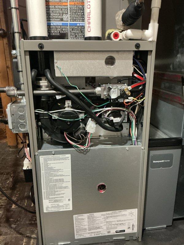 Completed Gold-level preventive maintenance inspection on 1-year-old Lennox furnace and air conditioning system. Performed comprehensive inspection of furnace components including blower assembly, gas valve, heat exchanger, and electrical connections in basement location. Evaluated outdoor condensing unit including fan motor operation and coil condition. Investigated customer concern regarding condensation pump vibration and potential mold growth in discharge line connected to furnace; inspected pump operation and drainage system. Documented equipment condition with photographs showing internal furnace components and exterior AC unit. All systems operational at time of inspection.