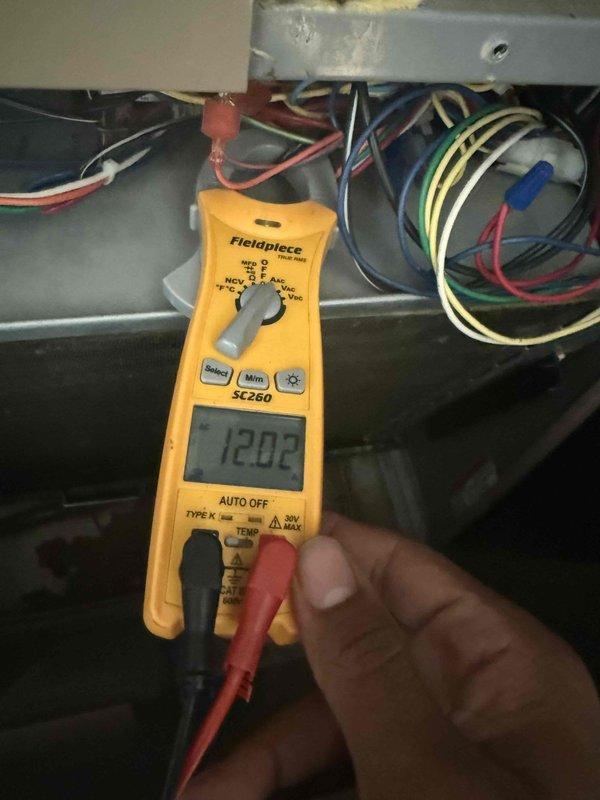 Responded to service call for air conditioning system not keeping up with cooling demand in 5-year-old condo unit. Upon arrival, coordinated access through building reception and conducted diagnostic evaluation of the system. Performed visual inspection of evaporator coil assembly, noting oxidation and discoloration on copper tubing consistent with age and normal operation. Verified electrical supply to system using digital multimeter, confirming proper voltage at 120.2V to control circuit. Inspected internal components including heat exchanger coils, insulation, and drain pan for signs of damage, leaks, or obstruction. Documented system condition through photography for service records.